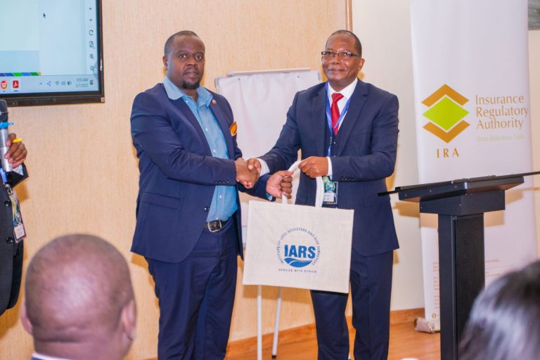 IARS officials exchanging a gift at the conference