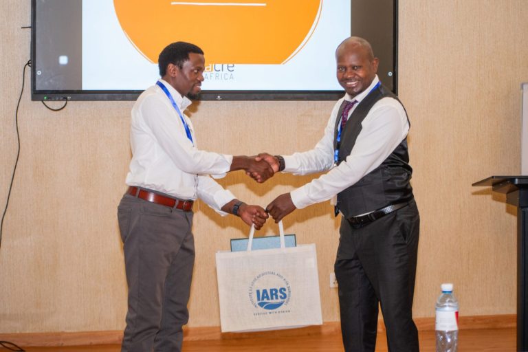 Handshake and gift presentation at an IARS event