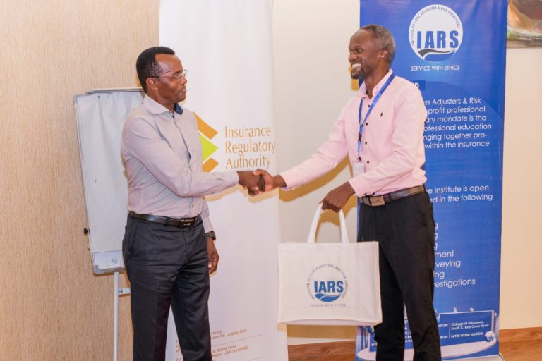 Speaker receiving an IARS gift bag after a session